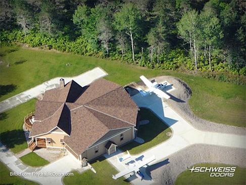 Hangar home with multiple hydraulic doors