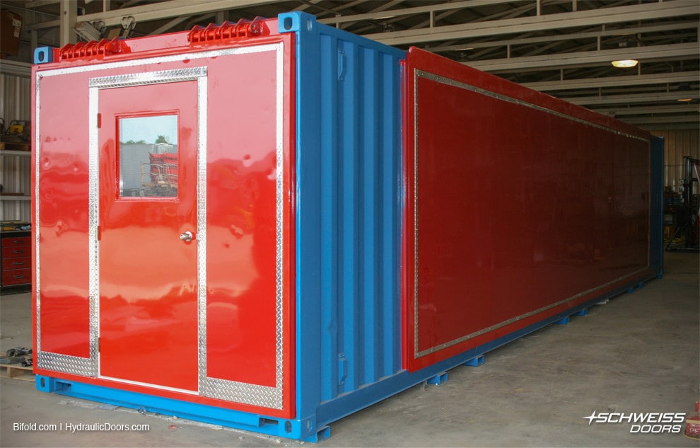 Schweiss Hydraulic Doors on container with walk door