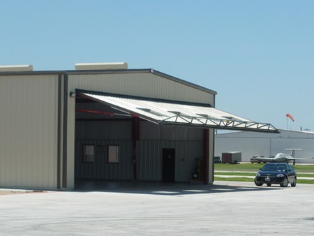 The hangar gets protection from the sun and rain when Schweiss Hydraulic Doors is open.