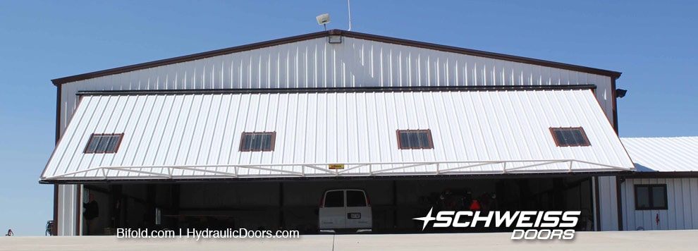 Hydraulic door with photo eye, remote, and backup system