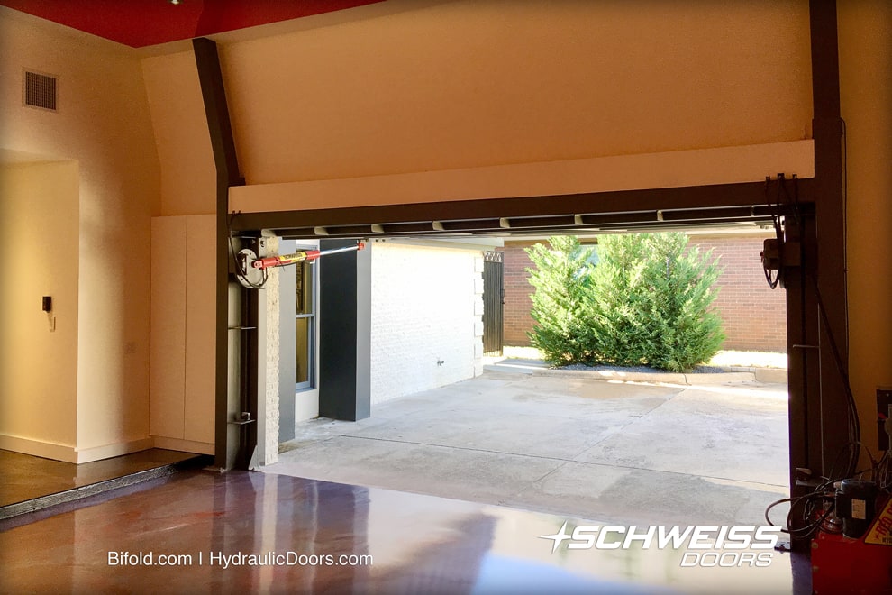 Garage with Schweiss Door has tall ceiling for possible two-car lift