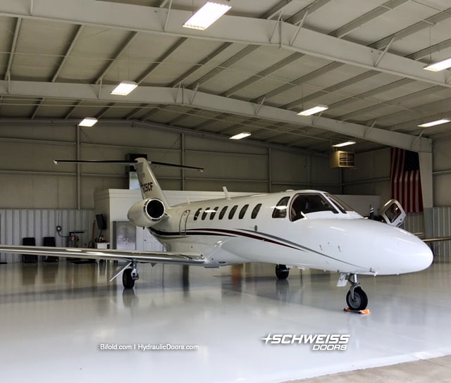 Citation CE-525 inside hangar with Schweiss Door